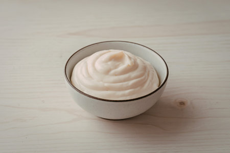 A photo of a white bowl containing mayonnaiseの写真素材