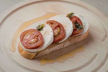 sliced cherry tomatoes, sliced mozzarella cheese, and basilの写真素材