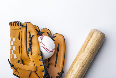 a baseball glove with a ball and a bat on a white surface