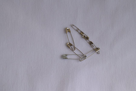 Safety pins on a white background. Sewing accessories.