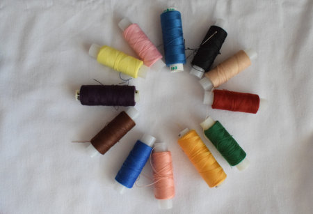 Needles on a red cloth on a white background. Sewing accessories.