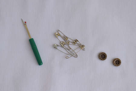 Push pins, pins, buttons on a white background. Sewing accessories.の写真素材