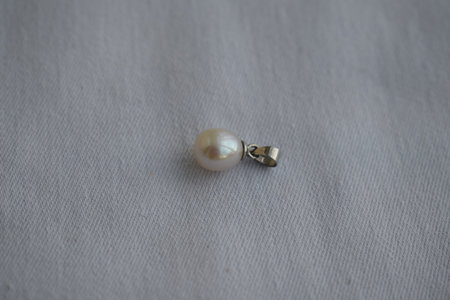Pearl pendant on a white background. Goods for creativity and needlework.の写真素材