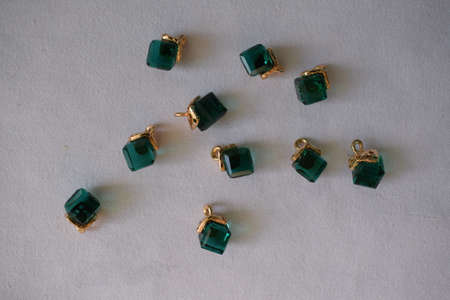 Green square beads on a white background. Goods for creativity and needlework.の写真素材