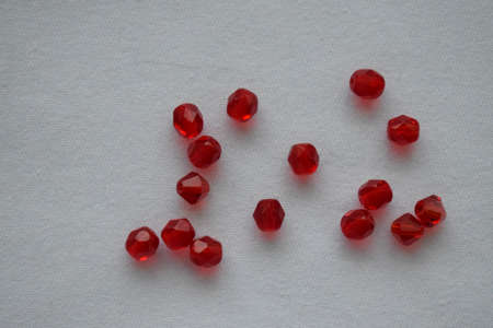 Red beads on a white background. Goods for creativity and needlework.の写真素材