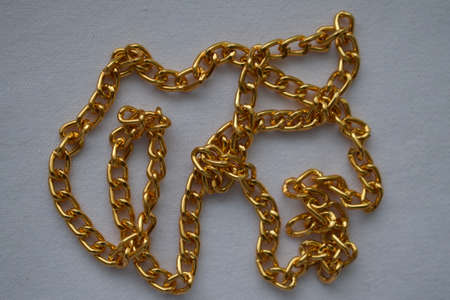 Gold chain on a white background. Goods for creativity and needlework.の写真素材