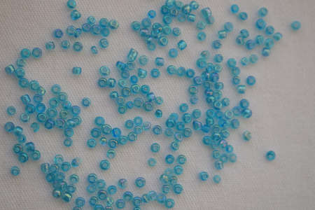 Blue round beads on a white background. Goods for creativity and needlework.の写真素材