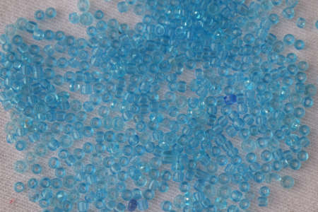 Blue round beads on a white background. Goods for creativity and needlework.の写真素材