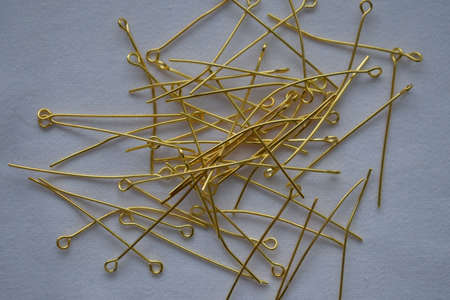 Gold metal pins on a white background. Goods for creativity and needlework.の写真素材