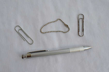 Stationery. Pen and paper clips on a white background. The view from the top.の写真素材