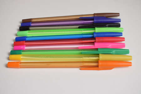 Stationery. Ballpoint pens of different colors on a white background. The view from the top.の写真素材