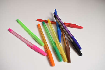 Stationery. Ballpoint pens of different colors on a white background. The view from the top.の写真素材