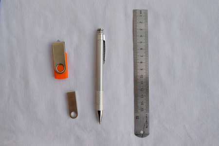 Stationery. Ruler, pen and flash drives on a white background. The view from the top.の写真素材