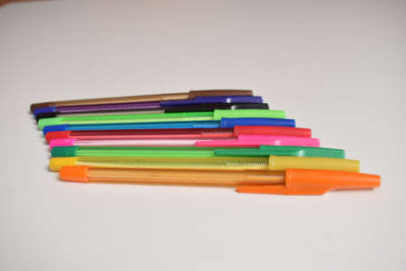 Stationery. Ballpoint pens of different colors on a white background. The view from the top.の写真素材