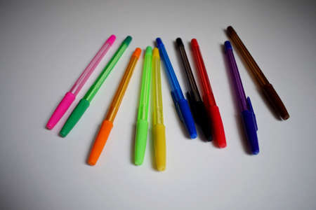 Stationery. Ballpoint pens of different colors on a white background. The view from the top.の写真素材