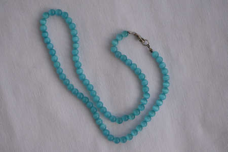 Beautiful beaded necklace. Handmade decoration. Blue and white colors.の写真素材