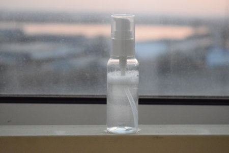 A bottle of liquid on the window. The view from the top.の写真素材