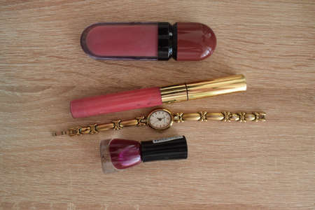 Women's accessories, cosmetics, skin care on a wooden table. The view from the top.の写真素材