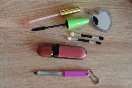 Women's accessories, cosmetics, skin care on a wooden table. The view from the top.の写真素材