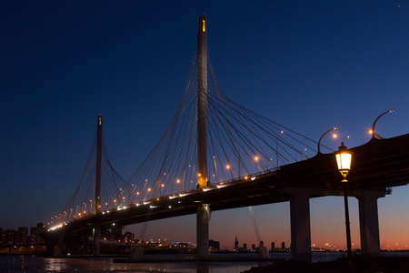 Large suspension bridge over the Neva River and the Bay in St. Petersburg, Russia, at sunsetの写真素材