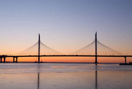 Large suspension bridge over the Neva River and the Bay in St. Petersburg, Russia, at sunsetの写真素材