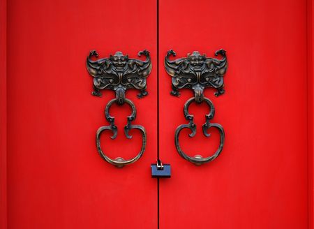bat door knocker on red doorの写真素材