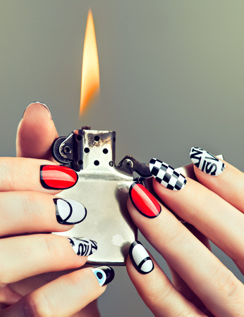 Well groomed womans hands with original modern designed manicure on finger nails.の写真素材