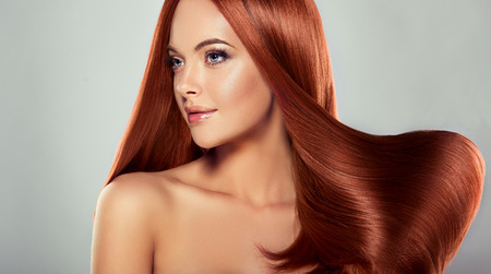 Young, brown haired beautiful model with long,  straight, well groomed hair. Excellent hair wave.の写真素材
