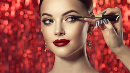 Make up artist is working with face of perfect model. Cosmetic and make up.の写真素材