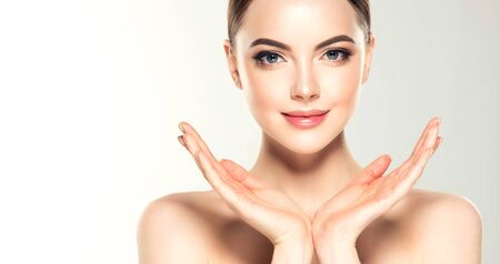 Gorgeous, young woman with clean. Soft make up and light smile on the perfect face.Facial treatment.の写真素材