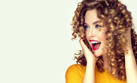 Portrait of loudly screaming young beautiful model.  Incredibly surprised woman. Entertainment and advertisement.の写真素材