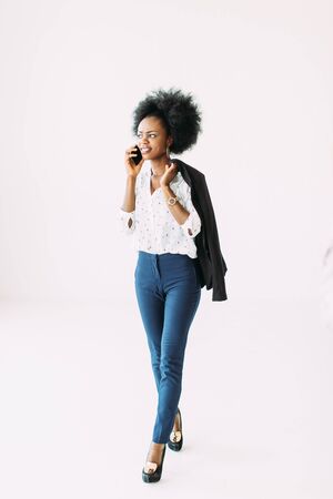 Smiling young afro american business woman using cell phoneの写真素材