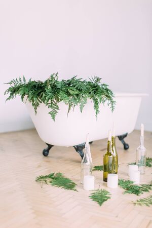 White bath decorated with fern and candles.の写真素材