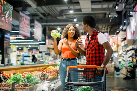African Couple shopping in supermarket produce departmentの写真素材