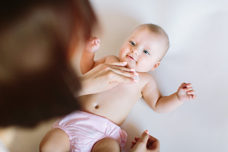Mother cleaning newborn baby skin.