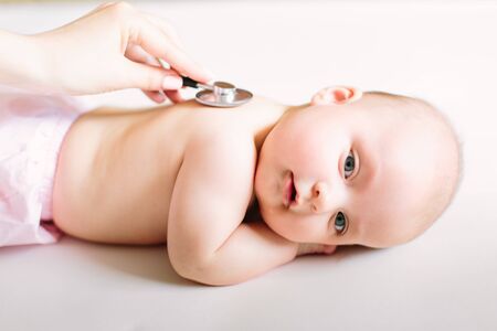 Doctor Using A Stethoscope To Listen To Baby's back , Baby Health Concep.の写真素材