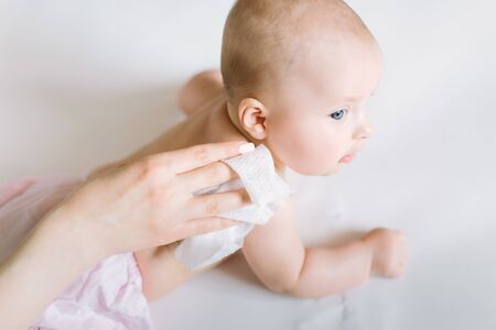 Mother Wiping Baby's shoulder.の写真素材