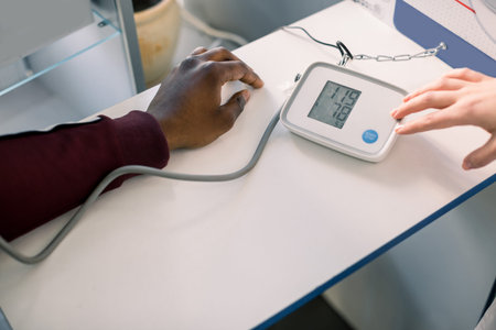 Close Up Of A Doctor Checking Blood Pressure Of A Patient. Doctor cardiologist measuring blood...