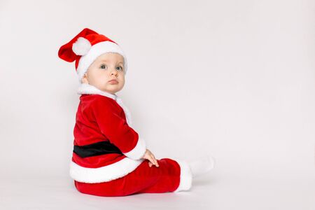 Happy baby girl celebrating Christmas isolated on white background.の写真素材