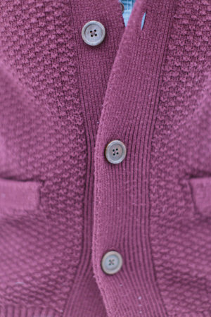 Stylish knitted burgundy sweater with buttons.