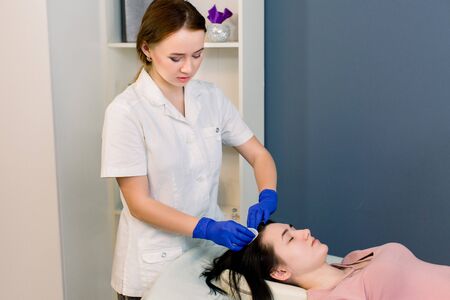 Procedure of mesotherapy. The doctor cosmetologist makes the beauty procedure in womans head. Strengthen hair and their growth.の写真素材
