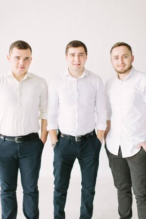 Crazy groom and groomsmen have fun posing on the studioの写真素材