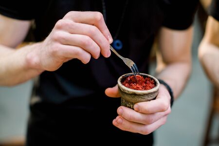A man prepare hookah sisha in hookah bar. Tabaco preparation.の写真素材
