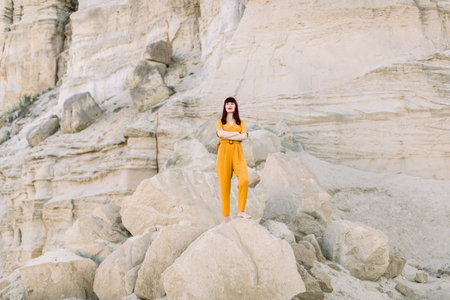 Full length horizontal summer portrait of a young brunette charming woman in fashionable yellow...