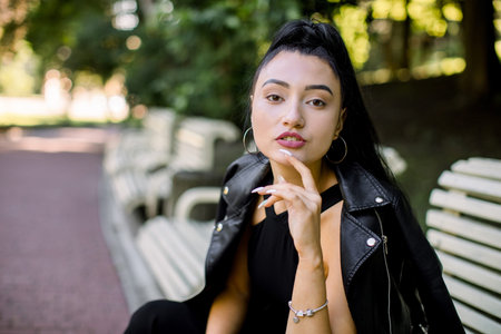 Half length horizontal portrait of beautiful sexy dreamy young Asian woman, wearing black...