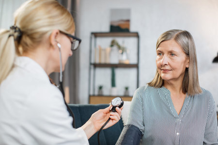 Close up photo of blood pressure measurement. blurred view of female nurse or doctor doing blood...