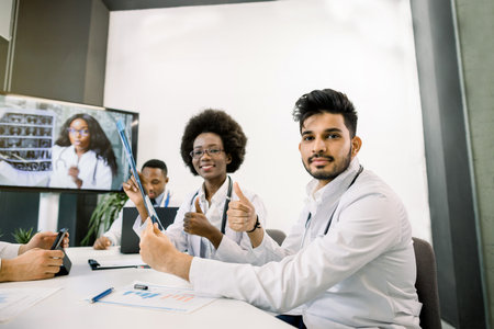 Healthcare, occupation, people and medicine concept. Group of happy multiethnic doctors on video...