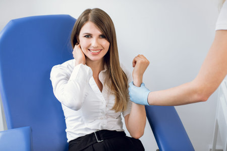 Portrait of a beautiful Caucasian business woman smiling to camera after getting a blood test in a...