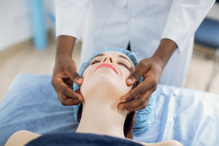 Relaxing treatment in medicine. Caucasian woman in disposable cap, lying on the couch, enjoying...