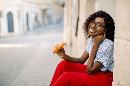 People, races, urban lifestyle and food concept. Close up portrait of cheerful smiling dark skinned...
